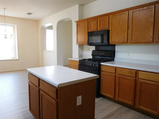 a kitchen with a sink stove and microwave