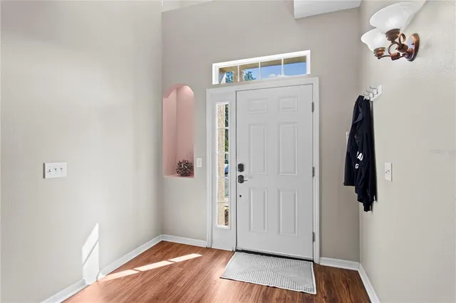 a view of a big building with a big yard and large trees