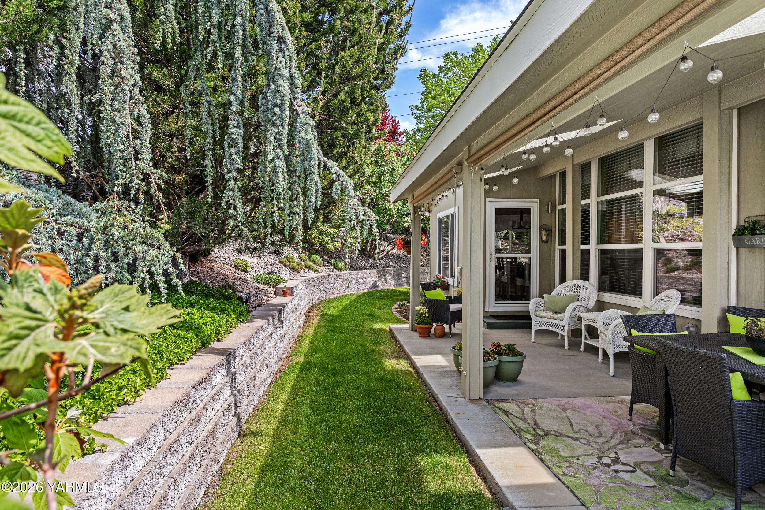 a view of an chairs and table in backyard of the house