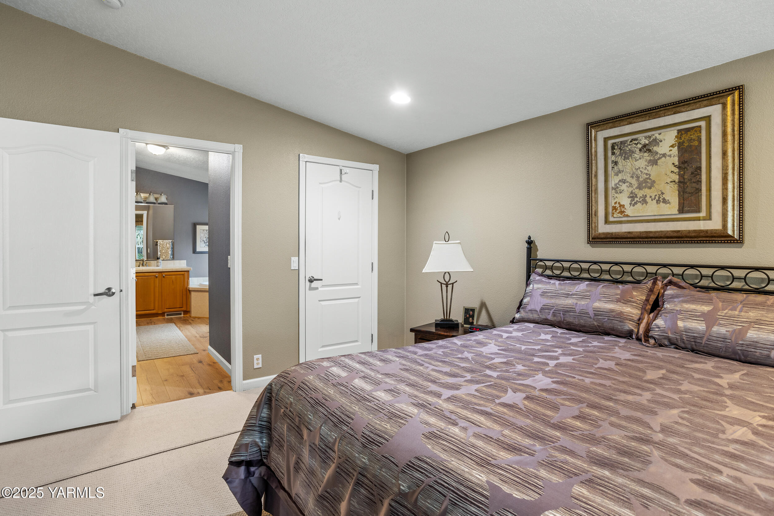 200 Bridle Way, Unit 203 Yakima, WA 98901 - Photo 15 of 36 a bedroom with a large bed and a chandelier
