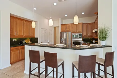 a large kitchen with a table and chairs in it