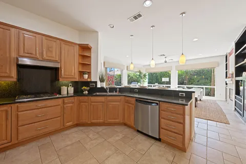 a kitchen with stainless steel appliances granite countertop a sink and cabinets