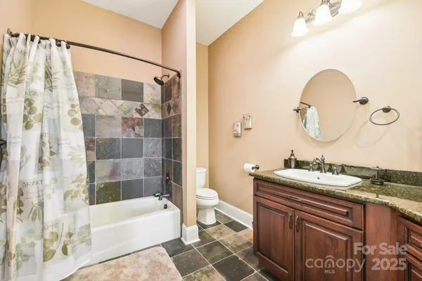a bathroom with a sink a toilet and bathtub