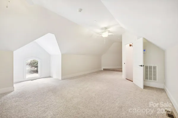 a view of a big room with closet and windows