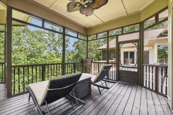 a view of a balcony with furniture and wooden floor