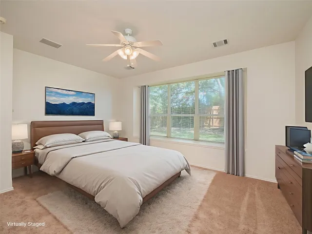 an empty room with a chandelier fan and closet