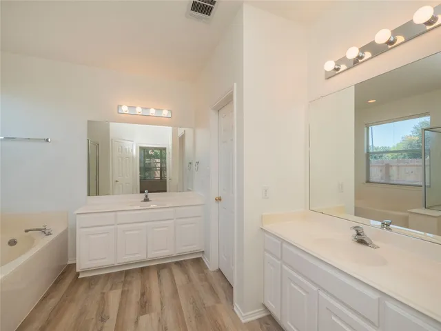 a bathroom with a bathtub and a shower