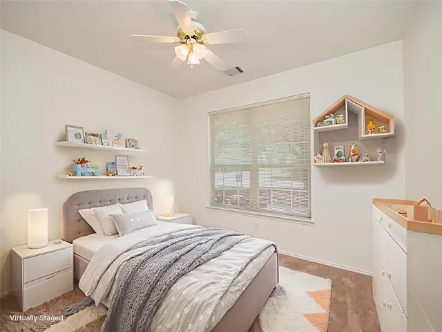 an empty room with a ceiling fan and a window