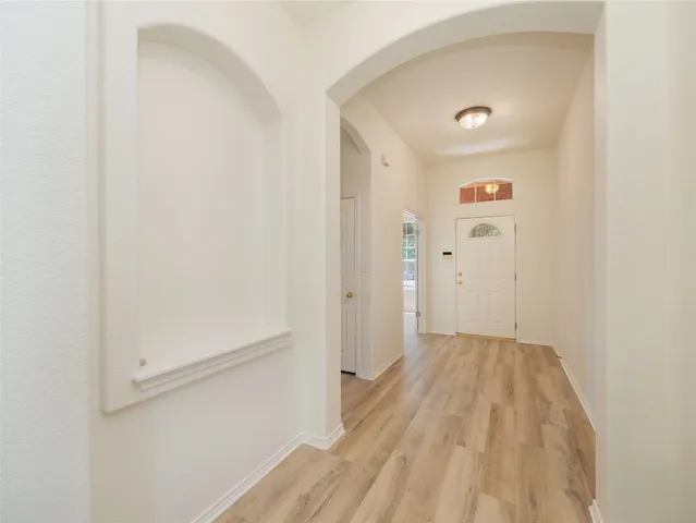 a view of a hallway view with wooden floor