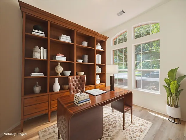 a view of empty room with wooden floor