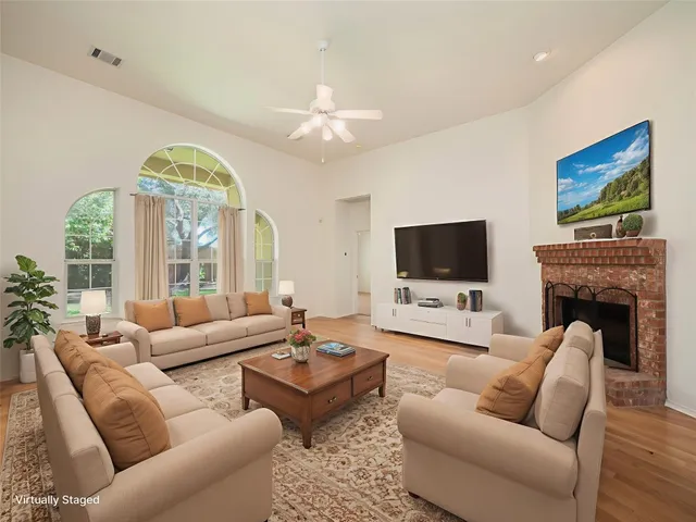 a view of a livingroom with an empty space and a fireplace