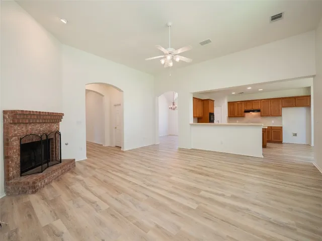 a dining room with furniture potted plants and wooden floor