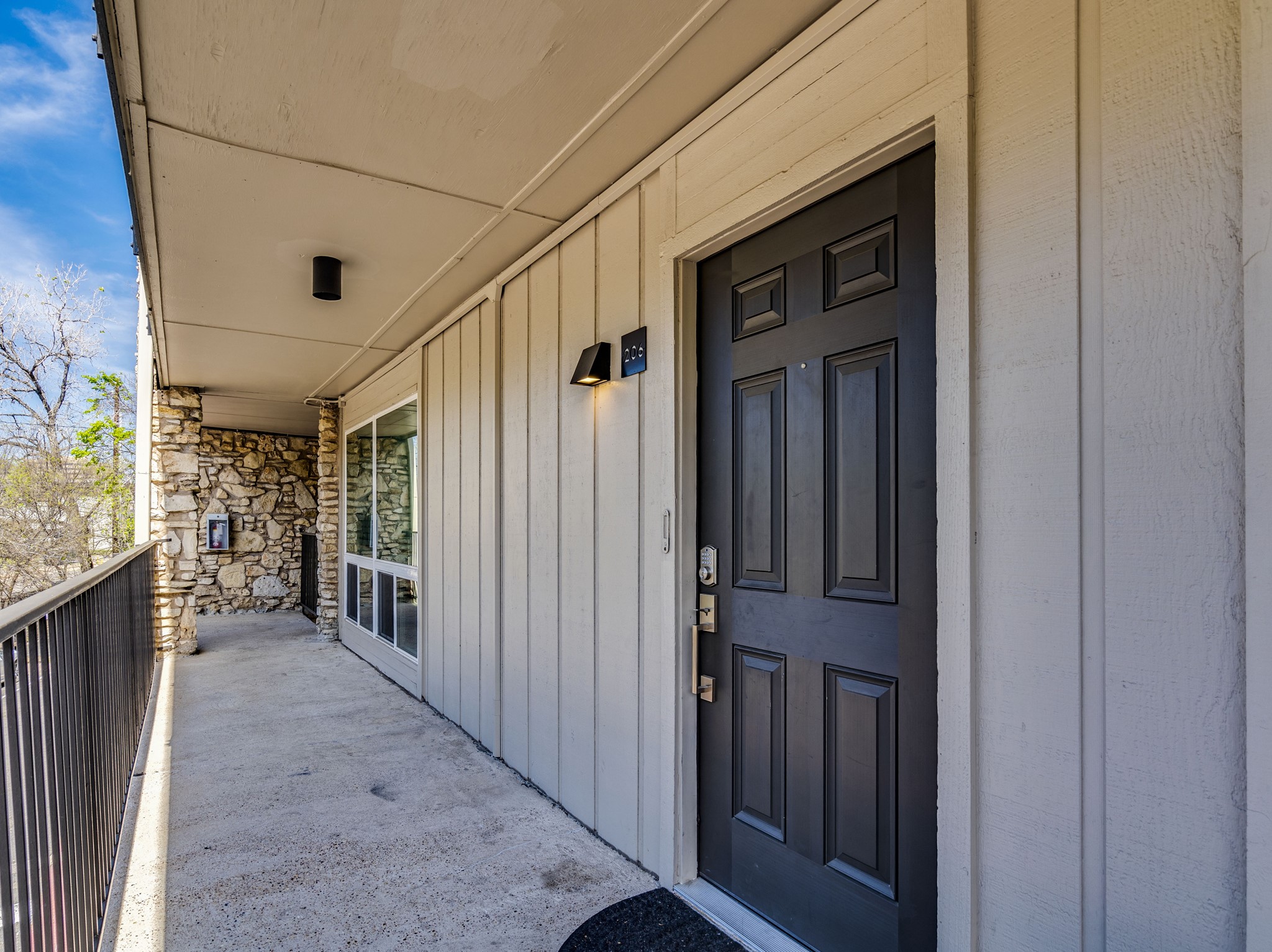 500 East Riverside Drive, Unit 206 Austin, TX 78704 - Photo 30 of 32 Doorway to property featuring board and batten siding and stone siding