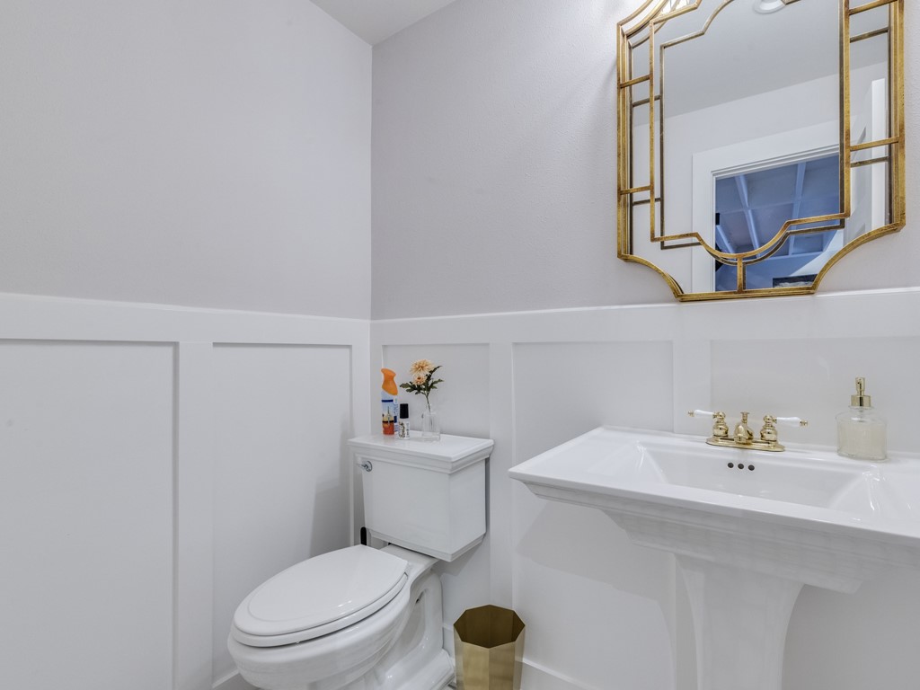 500 East Riverside Drive, Unit 206 Austin, TX 78704 - Photo 10 of 32 Half bathroom featuring a decorative wall and a wainscoted wall