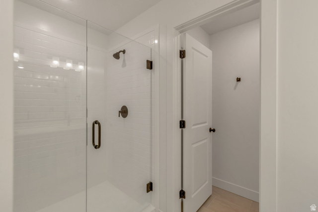 30 South Moonlit Road Mapleton, UT 84664 - Photo 14 of 25 Walk-in shower featuring subway tile surround, clear glass enclosure, and bronze fixtures
