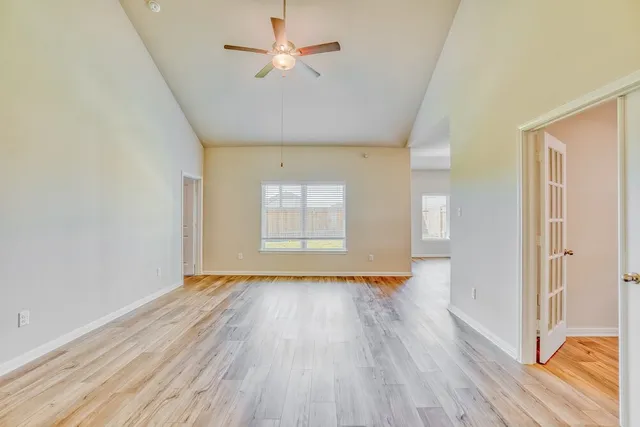 wooden floor in an empty room with a window