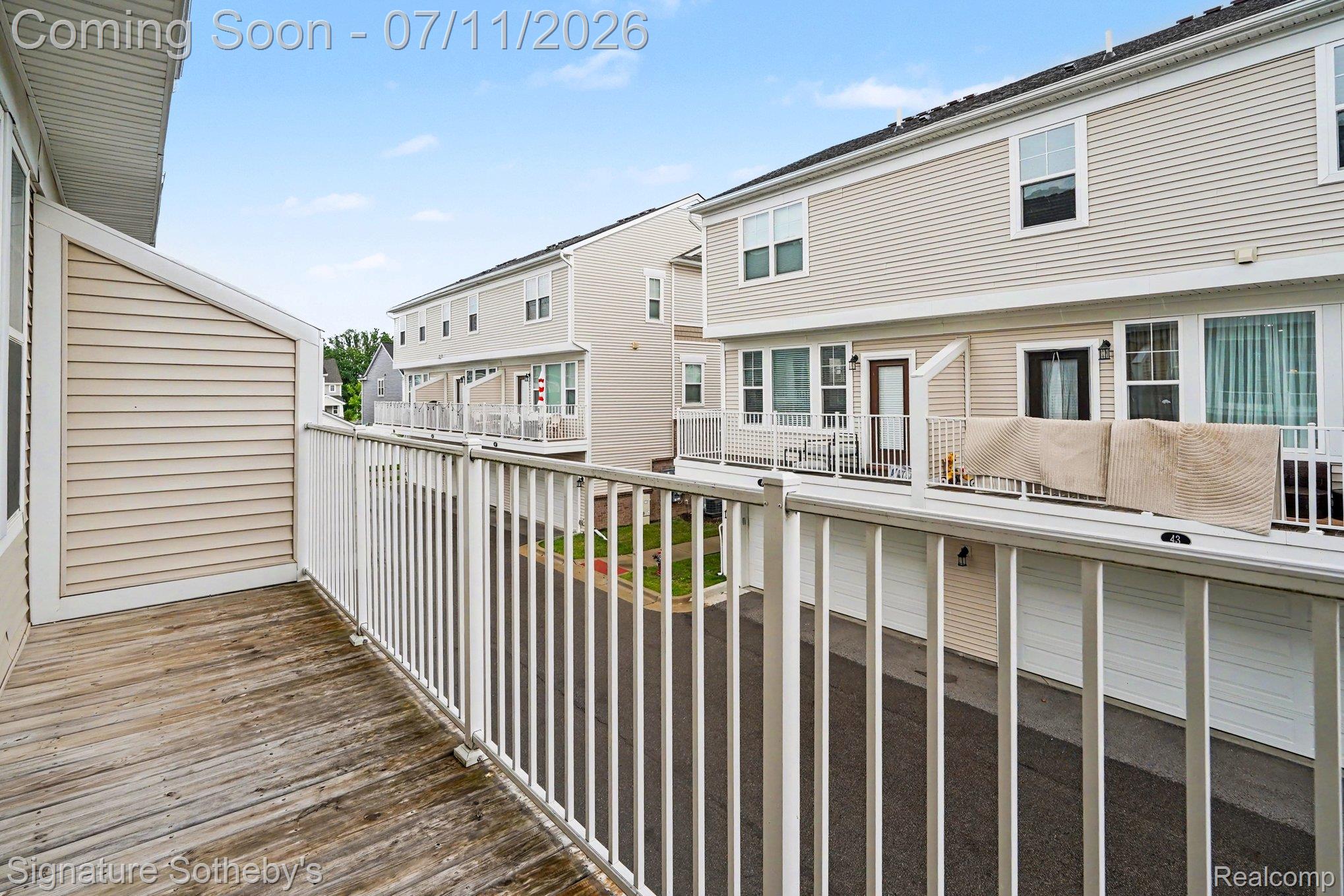 2500 Normandy Road, Unit 40 Royal Oak, MI 48073 - Photo 24 of 26 Private exterior balcony featuring wood-finish decking and white metal railings