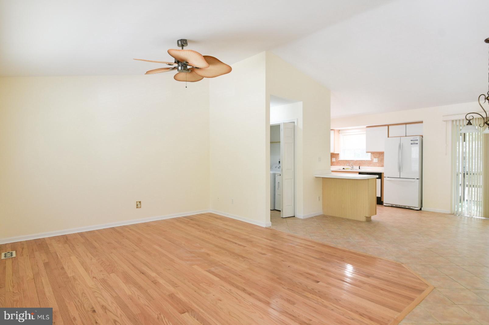 61 Abbyshire Road Ocean Pines, MD 21811 - Photo 12 of 40 a view of kitchen and empty room with wooden floor