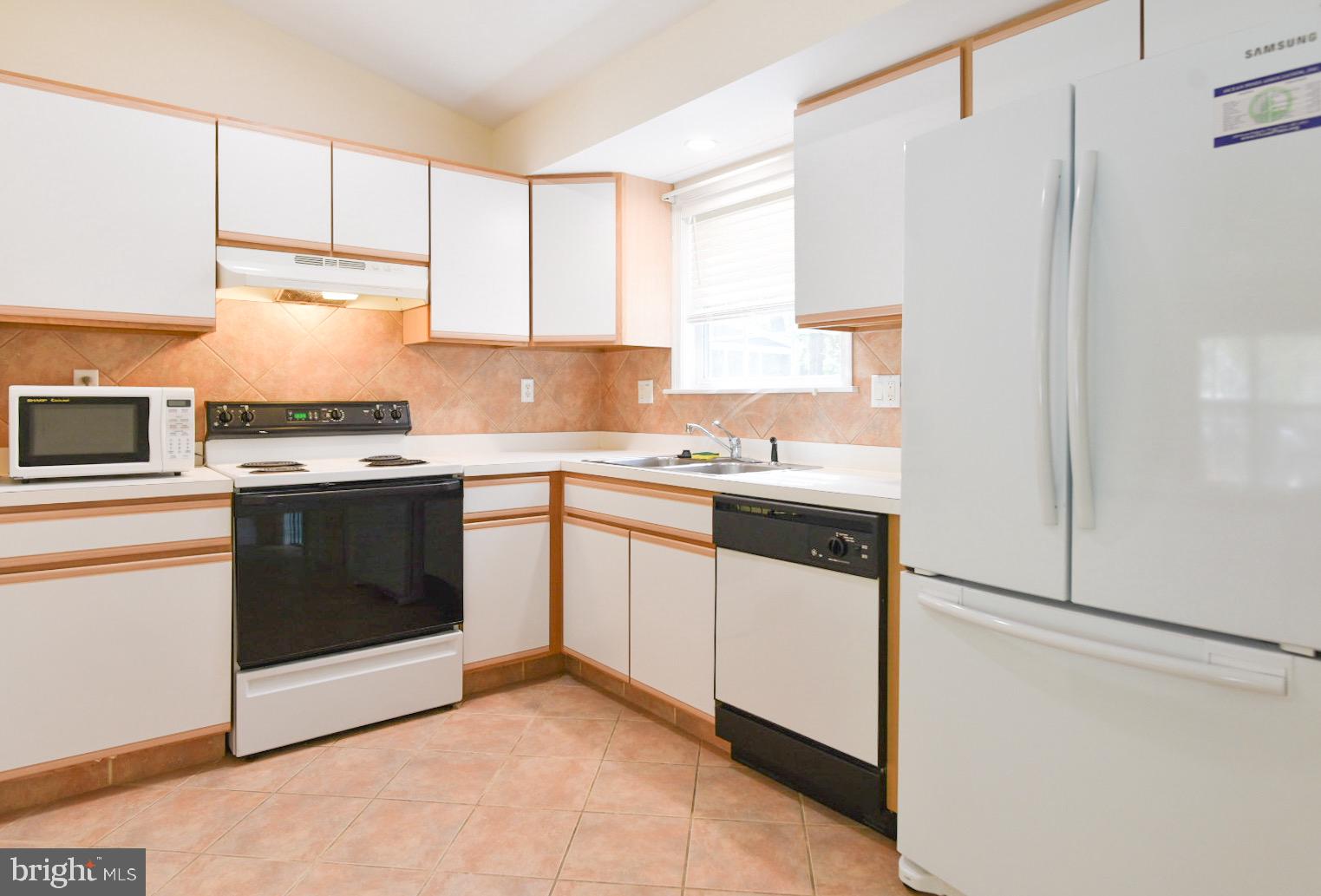61 Abbyshire Road Ocean Pines, MD 21811 - Photo 2 of 40 a kitchen with stainless steel appliances white cabinets and a refrigerator