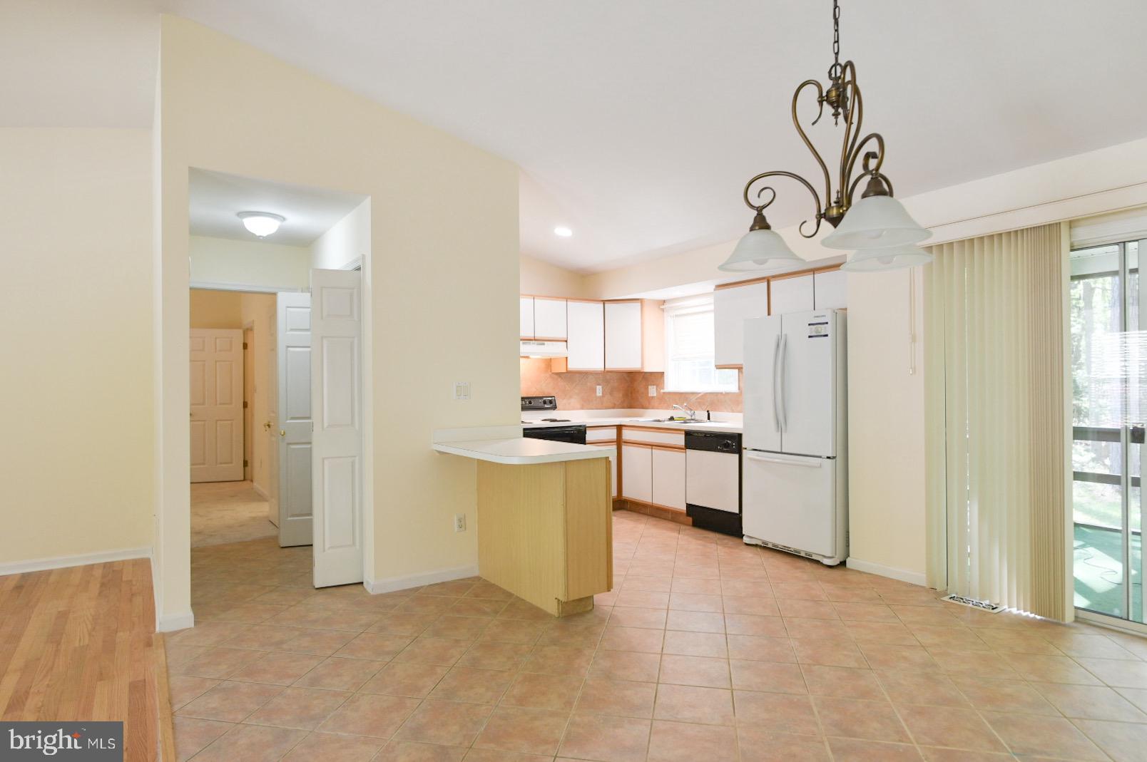 61 Abbyshire Road Ocean Pines, MD 21811 - Photo 3 of 40 a kitchen with white cabinets and stainless steel appliances