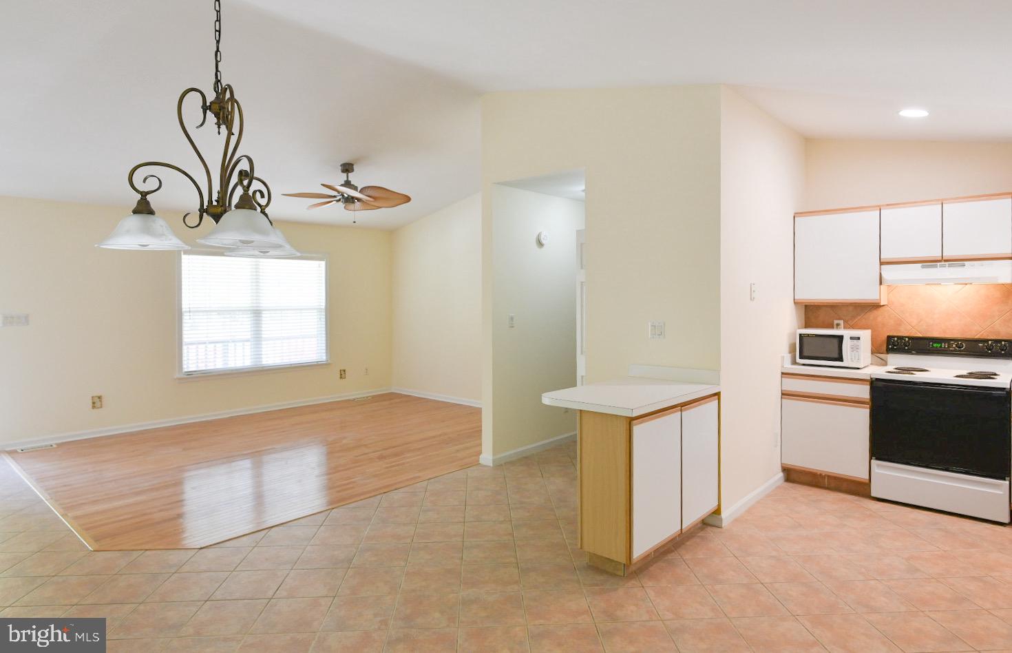 61 Abbyshire Road Ocean Pines, MD 21811 - Photo 4 of 40 a kitchen with stainless steel appliances a stove a refrigerator and a sink