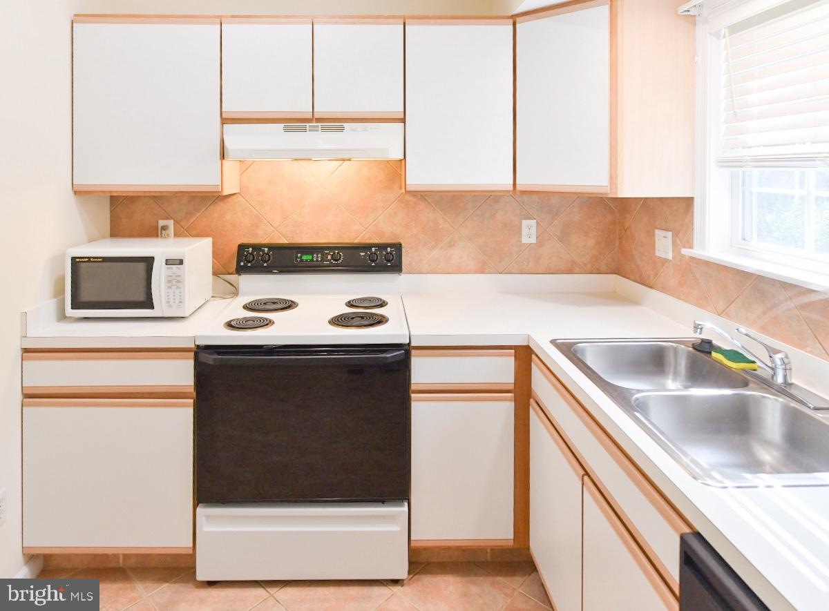 61 Abbyshire Road Ocean Pines, MD 21811 - Photo 7 of 40 a kitchen with a sink cabinets and a window