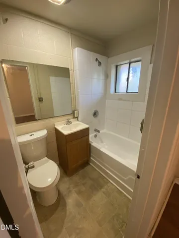 a bathroom with a toilet a sink and bathtub