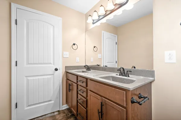 a bathroom with a sink a mirror and a shower