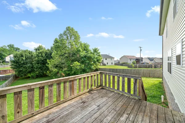 a view of balcony with wooden floor and fence