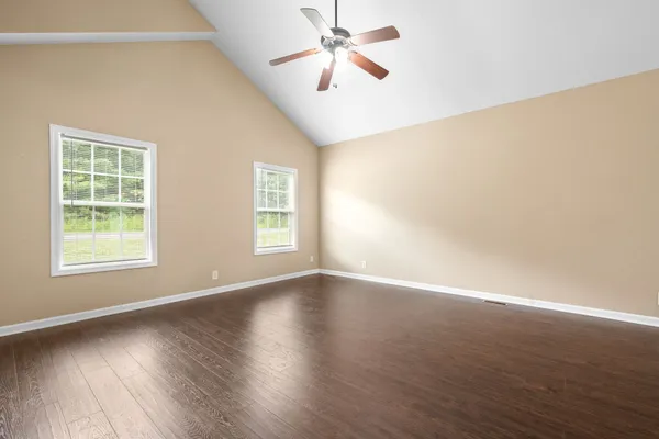 wooden floor in an empty room with a window