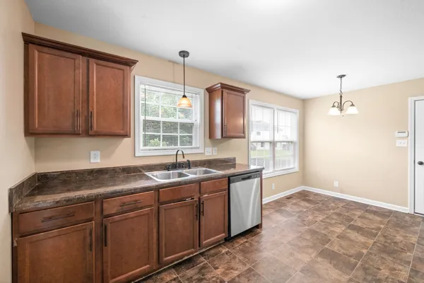 a kitchen with a sink stove and cabinets