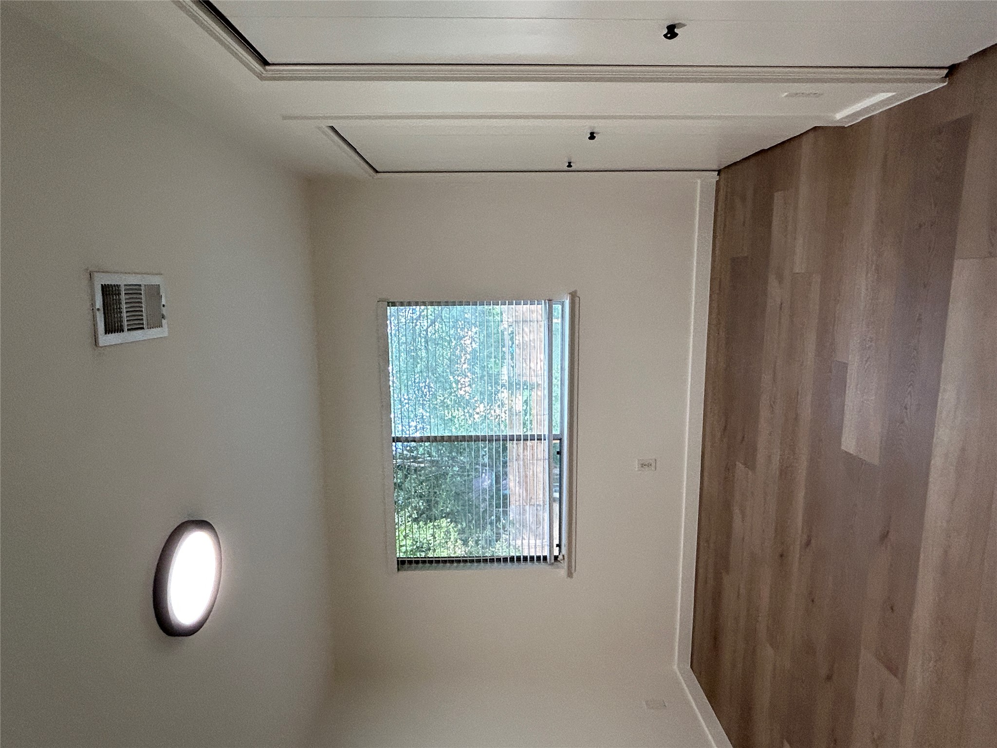 6603 Ripple Run Austin, TX 78744 - Photo 11 of 16 Well-lit room with wood plank flooring offers a clean, versatile canvas for personal style.