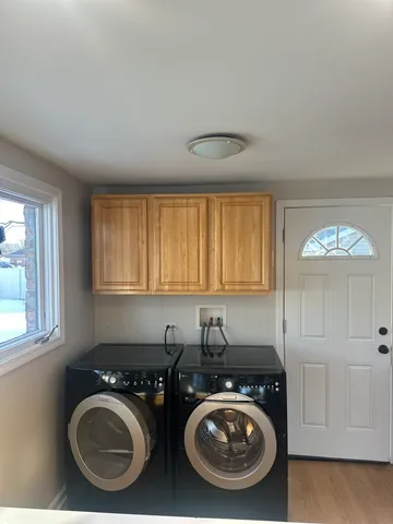 a utility room with sink washer and dryer