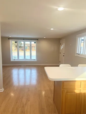 a room with wooden floor and a floor to ceiling window