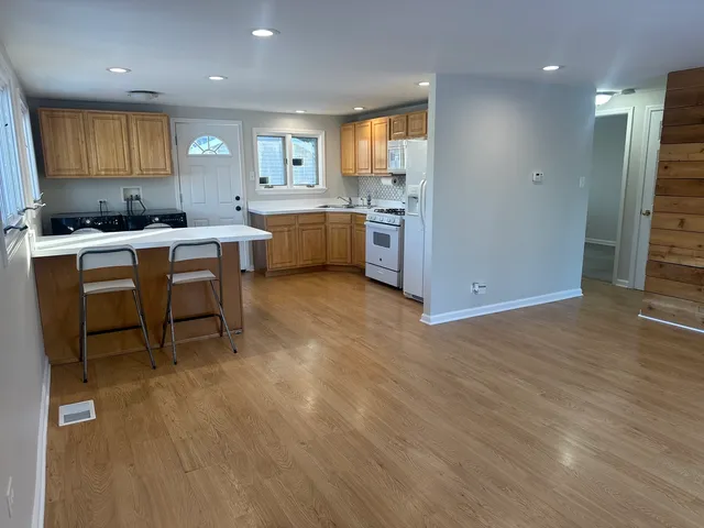 a kitchen with a sink cabinets and wooden floor