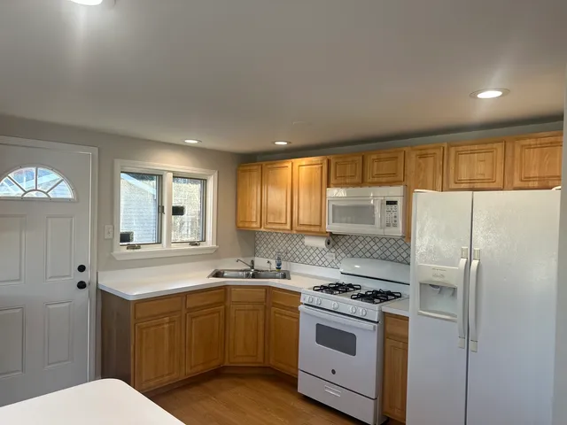 a kitchen with a refrigerator sink and cabinets