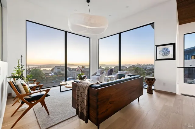 a spacious bedroom with a large bed and a chandelier