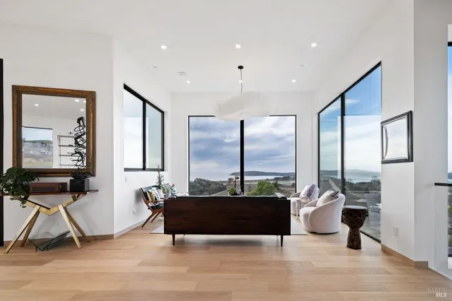 a spacious bedroom with a bed a couch and a large window