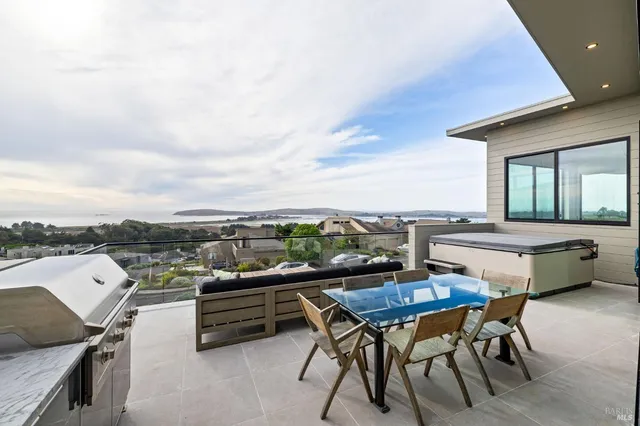 a bedroom with a large bed and a flat tv screen on dresser