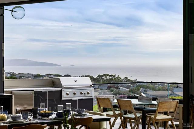 a view of a hallway with furniture and workspace