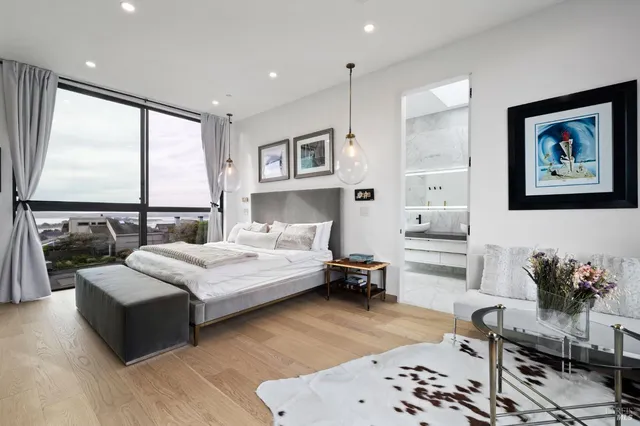 a living room with furniture and a floor to ceiling window