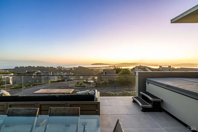 a living room with furniture large window and a flat screen tv