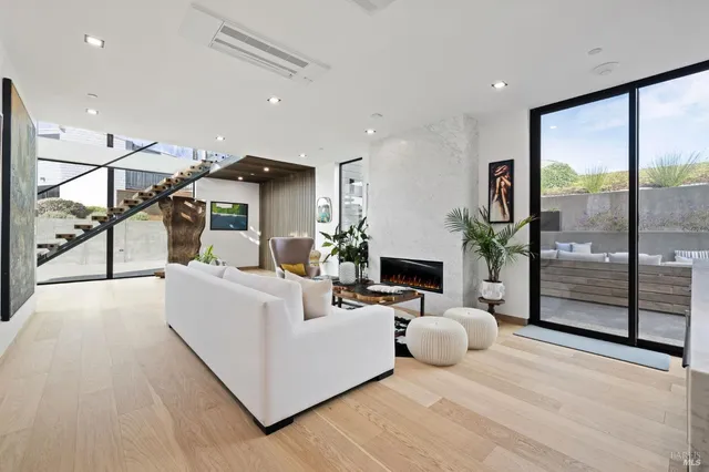 an aerial view of a house with a yard and ocean view