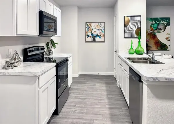 a kitchen with a sink and a stove top oven