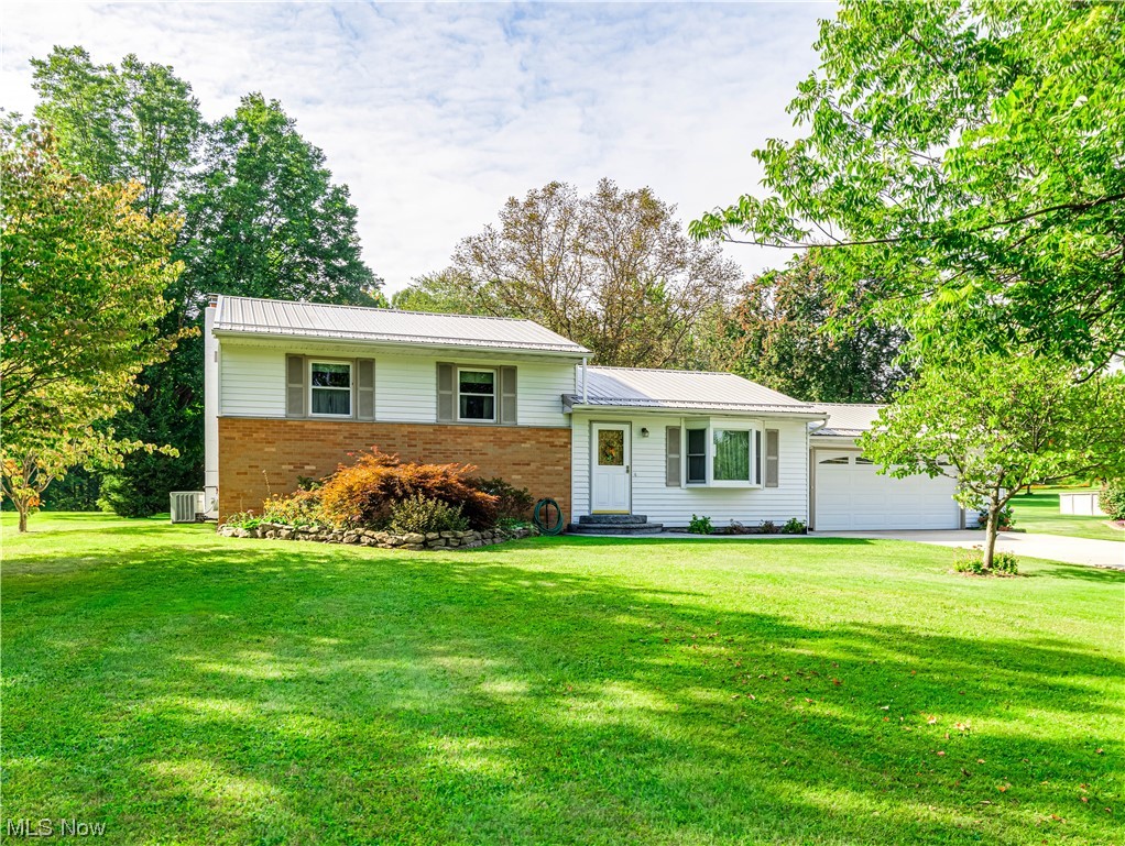 5200 Skinner Road Mantua, OH 44255 - Photo 1 of 23 View of front of home with a front yard and central AC