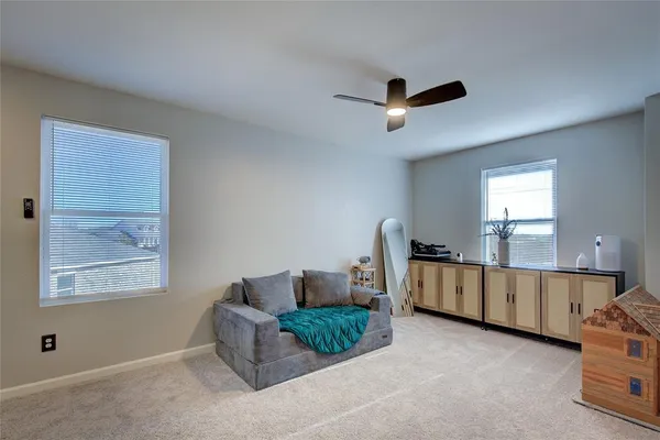 a bedroom with furniture and a window