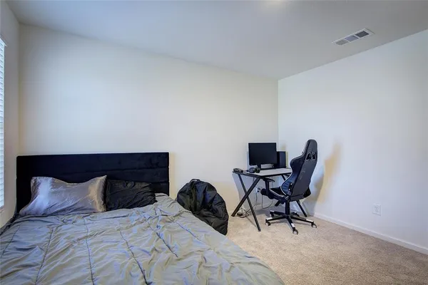 a bedroom with a bed and a chair