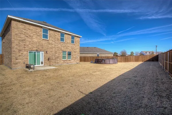 a view of a house with wooden fence