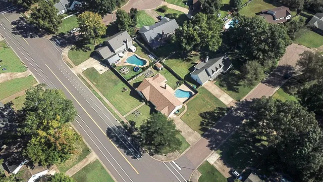 an aerial view of residential houses with outdoor space