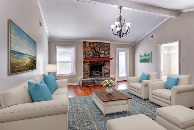 a living room with furniture and a chandelier